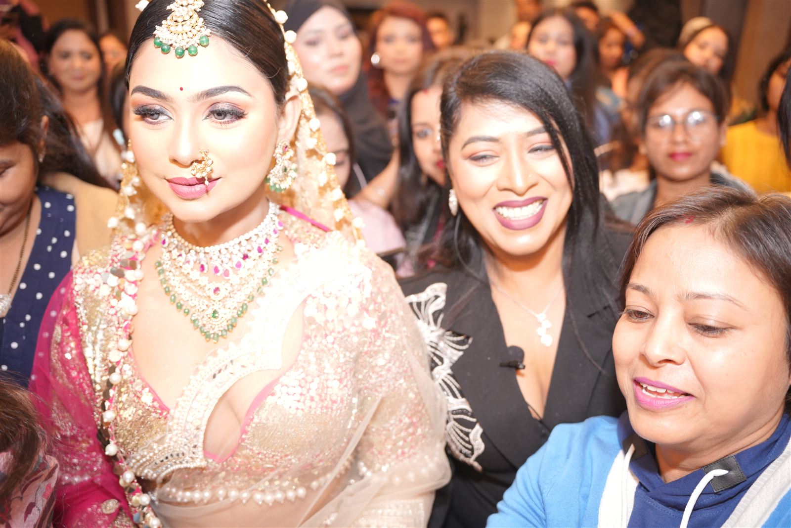 Attendees smiling with a bridal model after the reveal