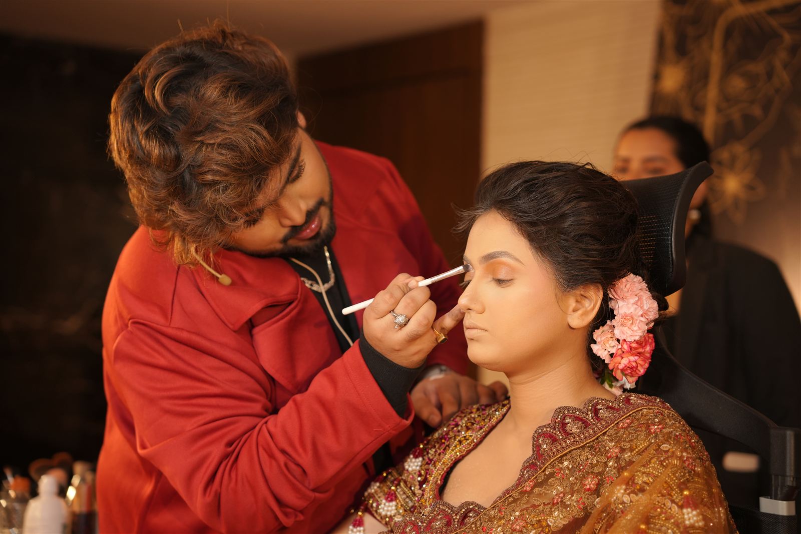 Headline artist applying makeup on a bridal model during the day two demo