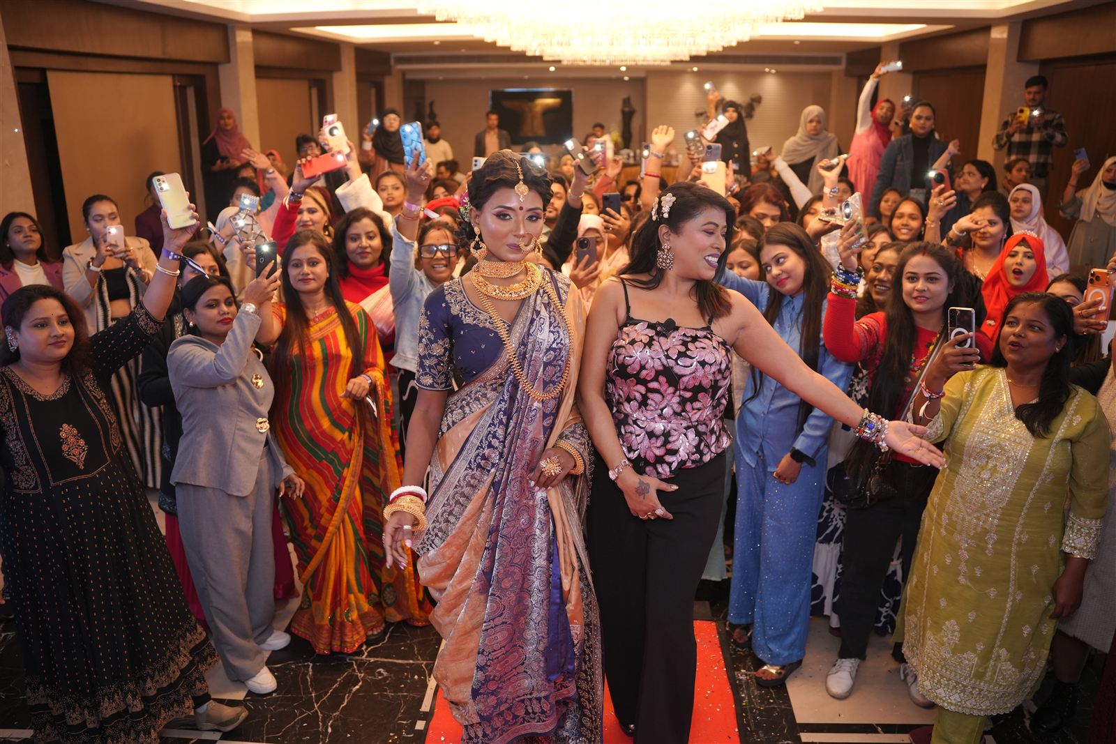 A packed hall cheering as models walk the floor